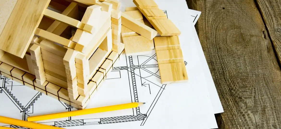 Many drawings for building and house on old wooden background.