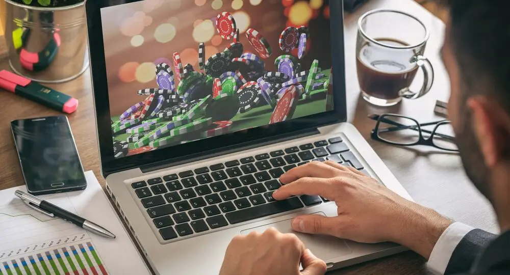 Casino,Chips,On,A,Computer,Screen.,Online,Gambling,Concept.,Man